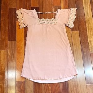 Women's short sleeve tunic top with decorative lace.